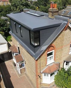 an aerial view of a house with a solar panel on the roof and two windows