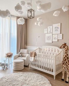 a baby's room with a giraffe statue in the corner and lots of clouds hanging from the ceiling