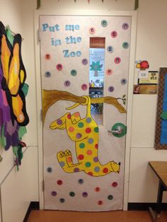 a classroom door decorated with polka dots and an image of a giraffe