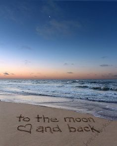 the message to the moon and back is written in sand at the edge of the ocean