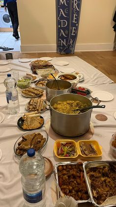 a table full of food is set up for people to eat at an event or social gathering