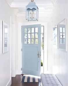 a blue door and bench in a hallway