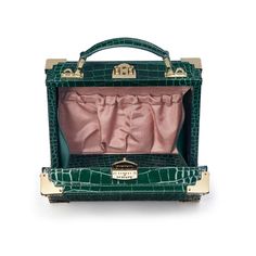 The Trunk in Evergreen Patent Croc Luxury Rectangular Cases, Luxury Box Bag With Leather Lining, Luxury Formal Box Bag With Leather Lining, Classic Green Box Bag For Formal Occasion, Classic Rectangular Box Bag With Original Box, Classic Gold Box Bag As A Gift, Classic Gold Box Bag As Gift, Luxury Rectangular Box Bag For Travel, Elegant Green Box Bag With Original Box