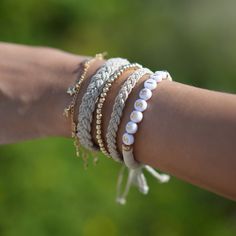 "Introducing our \"Hemp and Gold Tides Collection\" a breathtaking blend of natural and luxe elements designed to capture the enchanting allure of the beach.  You can purchase the bracelets individually or buy the complete set." Gold Wrap Bracelet With Round Beads For Beach, Gold Beaded Bracelets With Sliding Knot For Summer, Resizable Gold Beaded Bracelets For The Beach, Adjustable Gold Wrap Bracelet For The Beach, Stackable Beaded Bracelets For Beach, White Bohemian Braided Bracelets For Everyday, Gold Bohemian Braided Bracelets For Friendship, Gold Bracelets With Sliding Knot For Summer, Gold Sliding Knot Jewelry For Vacation