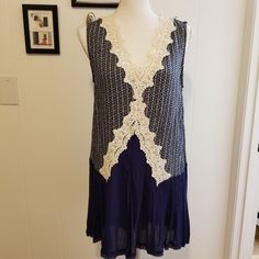 This Beautiful Top From Umgee Has A Navy And White Pattern With Crocheted Detail. It's Long So It Covers Your Assets. Nwt, Non Smoking Home. Flat Lay Measurements Are Approximate. Armpit To Armpit 19 Inches Top To Bottom 31 1/2 Inches Blue Lace Top For Summer, Lace Crochet Dress With Lace Trim For Day Out, Casual Crochet Lace Dress, Lace Crochet V-neck Dress, Crochet Trim Lace Top For Day Out, Lace Top With Crochet Trim For Day Out, Blue Crochet Lace Top, Blue V-neck Crochet Dress For Vacation, Casual Crochet Dress With Lace Trim For Day Out