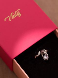 Surprise your loved one with a meaningful frog ring with a unique design. Available in 22k gold plating or platinum plating, it is a delightful piece that will mark your love story. Crafted from brass with an adjustable ring band, it is an excellent choice if you are looking for a distinctive design. The aesthetics feature a frog holding a crown adorned with sparkly cubic zirconia. It is an ideal option if you are looking for a cubic zirconia engagement ring that stands out among the rest. Amaze Elegant Open Snake Ring For Gift, Sterling Silver Snake Ring For Wedding, Elegant Cubic Zirconia Snake Ring Gift, Silver Snake Ring For Wedding, Silver Snake Ring For Wedding With Open Shape, Vintage Sterling Silver Snake Ring Gift, Elegant Adjustable Snake Ring As Gift, Vintage Sterling Silver Snake Ring As A Gift, Silver Cubic Zirconia Snake Ring As A Gift