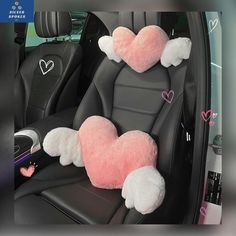 two pink and white heart shaped pillows in the back seat of a car with hearts on them