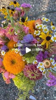 a vase filled with lots of different colored flowers