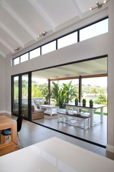 an open living room and dining area with sliding glass doors