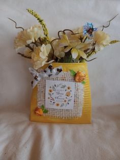 a vase filled with flowers on top of a bed