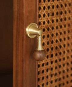 a close up of a door handle on a wooden door