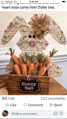 a wooden box filled with carrots sitting on top of a table next to a sign