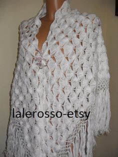 a white crocheted shawl on top of a mannequin