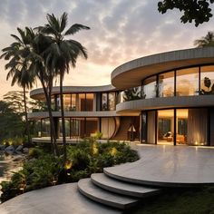 a modern house that is surrounded by palm trees and water at sunset or dawn with stairs leading up to the upper level