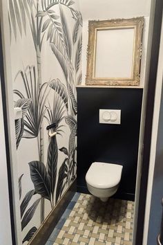 a bathroom with black and white wallpaper has a toilet in the corner, next to a mirror