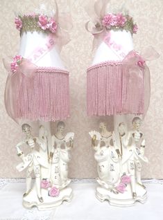 two lamps with pink and white decorations on them