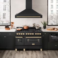 a black stove top oven sitting inside of a kitchen next to a wall mounted oven