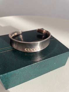 Vintage Gucci sterling silver 925 cuff bracelet with engraved Gucci at the centre. ★ Measurements: length: 9.25" ★ Label/Designer: Gucci made in Italia 925 ★ Condition: excellent Shipping Is Avaliable Worldwide. Every item is carefully shipped Priority via Air Mail - shipping takes from 7 to 14 working days, depending on your location. Shipping includes Tracking. ✩ visit the shop ✩ https://www.etsy.com/shop/Themagicstories2?ref=seller-platform-mcnav Thanks! Luxury White Gold Engraved Cuff Bracelet, Luxury Engraved White Gold Cuff Bracelet, Luxury Engraved Cuff Bracelet For Anniversary, Luxury Hallmarked White Gold Cuff Bracelet, Luxury Sterling Silver Cuff Bracelet Bangle, Luxury Sterling Silver Engraved Cuff Bracelet, Luxury Engraved Sterling Silver Cuff Bracelet, Luxury Polished Sterling Silver Cuff Bracelet, Luxury Silver Bracelets With Shiny Finish