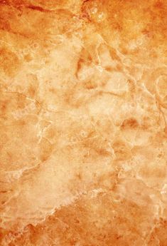 an orange and yellow textured wallpaper with some brown spots on the bottom half