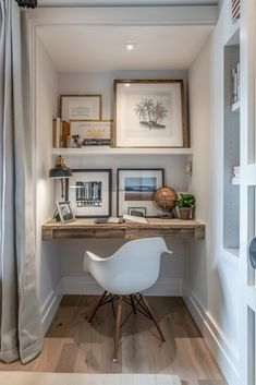 a white chair sitting in front of a desk with pictures on the wall behind it