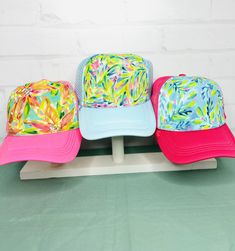 These adorable hand-painted whimsical trucker hats are the perfect pop of color for your summer look and the best gift for your friends and family. The size of the bill is 2 3/4". No two are alike. These hats are mesh back and have a snapback Playful Blue Summer Trucker Hat, Spring Vacation Fun Trucker Hat, Fun Spring Vacation Trucker Hat, Playful White Trucker Hat For Spring, Playful Blue Trucker Hat For Summer, Fun Trucker Hat For Vacation In Spring, Fun Blue Trucker Hat For Vacation, Fun Trucker Hat For Spring Vacation, Fun Curved Bill Beach Hat