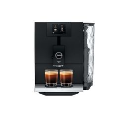 an espresso machine with two glasses of coffee on the front and one glass filled with liquid