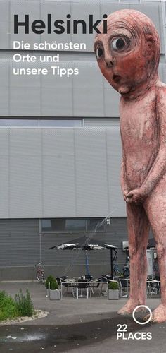 a statue of a bear in front of a building with the words helsink on it