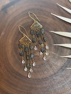 These boho chic earrings are made with gorgeous angled cut flashy labradorite and rainbow moonstone teardrops beautifully designed in a fringe style. The metal components are gold filled and non tarnish gold brass. These earrings measures close to 3 inches in length. Bohemian Teardrop Fringe Jewelry, Bohemian Brass Jewelry With Fringe, Bohemian Labradorite Earrings With Natural Stones, Wire Wrapped Labradorite Drop Earrings, Bohemian Labradorite Dangle Earrings, Fringe Fashion, Boho Chic Earrings, Chic Earrings, Quartz Cluster