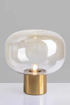 a light that is sitting on top of a table with a glass dome over it