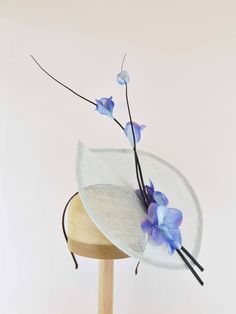 "Feel like you are in an airy dream with a floral celebration of spring using delicate ostrich quill sprays and flowers that arise from the leaf like sinamay base. This fascinator is available in a variety of colors. Pair it with any outfit that needs an extra touch of exuberant elegance. - Light Weight - Approximately 9\" X 12\" - Attaches with a headband. - Many color choices for sinamay base.  Please contact me if the color you want is not listed. - Each piece is unique and will vary slightly. If you have any special requests or questions please don't hesitate to contact me.  Color samples are available upon request. Need a different color?  Message me and I will do my best to meet your needs. This is a made to order item with production starting after order is placed.  Turnaround time Elegant Flower Headpieces For Spring, Spring Adjustable Fascinator With Handmade Flowers, Adjustable Flower Shaped Fascinator For Garden Party, Spring Fascinator With Flower Decoration, Spring Adjustable Fascinator With Flower Decoration, Adjustable Whimsical Fascinator With Curved Brim, Spring Evening Flower Fascinator, Flower-shaped Mini Hats For Spring Evenings, Fitted Whimsical Spring Fascinator