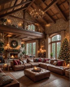 a living room filled with lots of furniture and a christmas tree in the middle of it