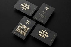 four black and gold business cards with chinese writing on the front, one in gold foil