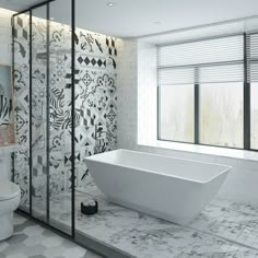 a white bathtub sitting next to a toilet in a bathroom with patterned walls and floors