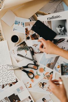 a table topped with lots of pictures and scissors