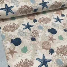 a blue and brown wallpaper with starfish, shells and corals on it