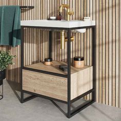 a white sink sitting next to a wooden cabinet