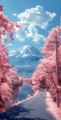 the road is lined with pink trees and mountains