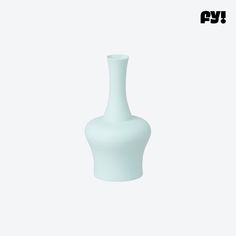 a white vase sitting on top of a table