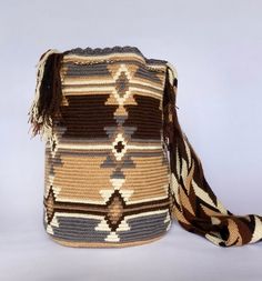 Mochila purse made by artisans of the Wayuu Indigenous Group in Colombia Purchased directly from Artisan, on a Fair Trade Basis Fully Handmade For each Wayuu Mochila Bag purchased, Hands of Colombia donates thread to Indigenous Artisans. Only ONE available Wayuu Mochila Purses are famous for their stunning designs and unique character. Each purse is handmade, full of expression and character. SIZE - Large. 12 inches deep (30.5cm), 13 inches wide (33cm). Comfortably fits large items: use as an ev Bohemian Beige Backpack, Handmade Natural Backpack For Everyday Use, Artisan Handwoven Bucket Bag, Bohemian Beige Rectangular Backpack, Handmade Bohemian Rectangular Backpack, Artisan Handwoven Crochet Bag For Travel, Artisan Beige Bucket Bag For Travel, Artisan Handwoven Crochet Travel Bag, Brown Bohemian Bucket Bag