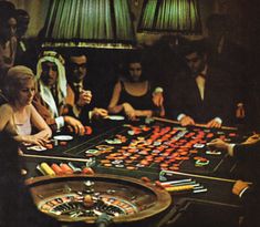 a group of people sitting around a casino table