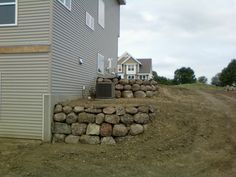 a pile of rocks sitting on the side of a house