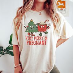 Celebrate the holiday season wearing our funny christmas pregnancy shirt.This shirt is perfect way to break the baby news!This merry and pregnant shirt makes a great gift for a reveal party, daughter or friend who is expecting a new baby and of course yourself! These t-shirts are Comfort Colors® brand , relaxed fit. Please use the measurements chart in the pictures section to determine your correct size. Please Size up for an oversized look. -Lay your favorite shirt at home flat and measure armp Vintage Christmas Shirt, Christmas Merchandise, Funny Thanksgiving Shirts, Comfort Colors Tshirt, Holiday Apparel, Christmas Tshirt, December 24th, Santa Shirts, Winter Shirts