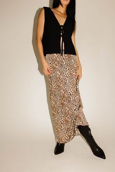 add a feisty touch to any outfit with this jaw-dropping leopard maxi skirt. guaranteed to turn heads, it has a silky, fitted silhouette with a stretchy elastic waistband. the perfect leopard printed skirt to dress up or down, season after season. leopard // maxi length, elastic waistband, scallop trim waist detail, bow detail paired with our good graces vest // black model is 5'8" + wearing a small measurements are approximate + taken while laying flat small : waist 26” length 37.5” medium : wai Leopard Print Long Skirt For Spring, Spring Leopard Print Maxi Dress For Night Out, Long Leopard Print Skirt For Spring, Leopard Maxi Skirt, Skirt To Dress, Casual Leopard Print Flowy Skirt, Long Flowy Leopard Print Skirt, Flowy Long Leopard Print Skirt, Leopard Maxi Skirts