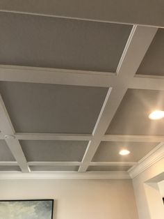 the ceiling in this room has been painted white and is being decorated with gray paint