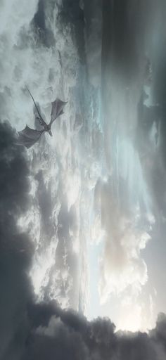 a dragon flying through the clouds in front of a bright light beam on top of it