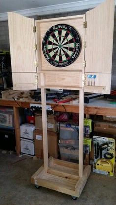 a wooden cabinet with a dart on it and darts in the back ground next to it