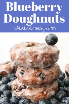 blueberry doughnuts stacked on top of each other with fresh blueberries around them