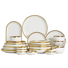 a white and gold dinner set with plates