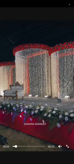 the stage is decorated with white and red flowers