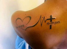 a woman with a cross and heart tattoo on her back